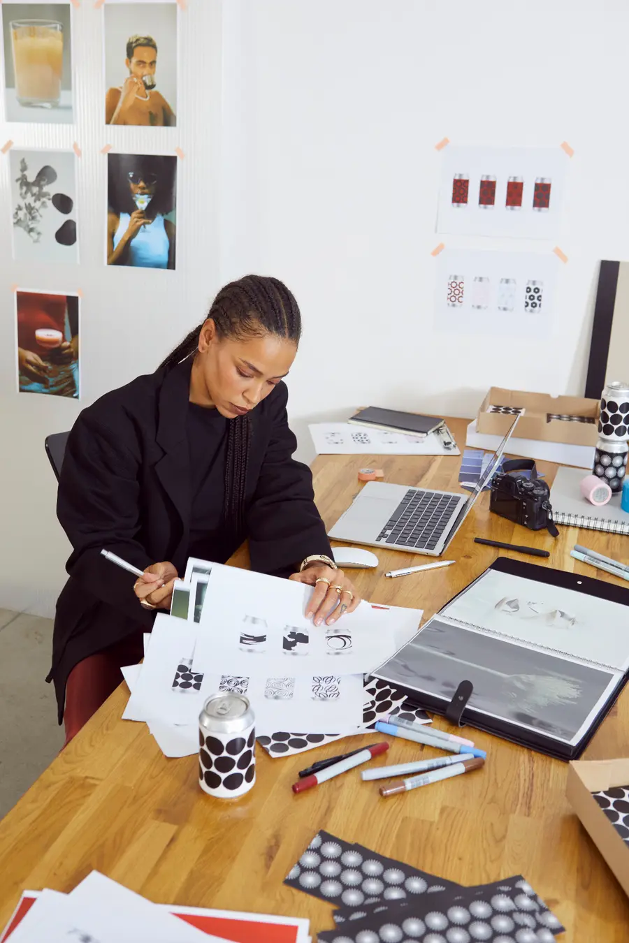 Designer reviewing printed packaging concepts at a worktable